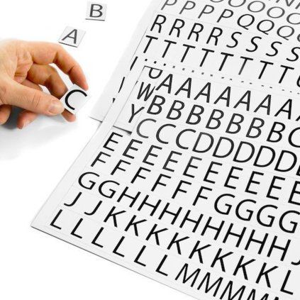 Magnetic letters and punctuation marks on two white A4 sheets for shelf labelling