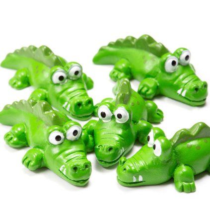 Five green crocodile-shaped fridge magnets