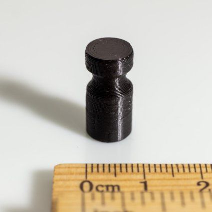 Small black cone-shaped neodymium magnet in a plastic case